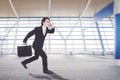 Asian businessman is running in the arrival hall Royalty Free Stock Photo