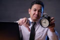 Asian Businessman Showing a Clock, Angry Expression