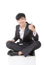 Asian businessman sit and give you an excellent sign Royalty Free Stock Photo