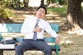 Asian businessman sitting in a park. Chest pain and heart attack Royalty Free Stock Photo