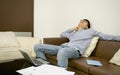 Asian businessman sleeping on sofa in living room at night Royalty Free Stock Photo