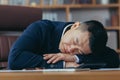 Asian businessman sleeping tired lying on the table, man at work Royalty Free Stock Photo