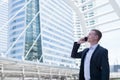 Asian businessman smile and using cell phone to talk about business success and financial future, with copy space