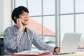 businessman smiling and talking on a mobile phone at home office desk Royalty Free Stock Photo