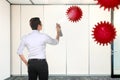 Asian businessman spraying disinfectant in the office room