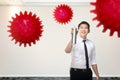 Asian businessman spraying disinfectant in the office room