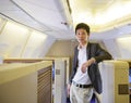 Asian businessman stand on first class cabin