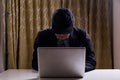 Asian businessman in suit attempting to hack computer network