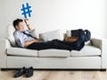 Asian businessman taking break laying on couch Royalty Free Stock Photo