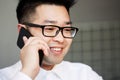 Asian businessman talking on the mobile phone in the office