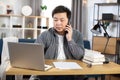 Asian businessman talking on mobile and working on laptop Royalty Free Stock Photo