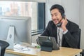 Asian businessman talking on telephone call at business workplace Royalty Free Stock Photo