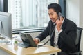 Asian businessman talking on telephone call at business workplace Royalty Free Stock Photo