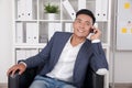 Asian businessman talking to his wife on phone Royalty Free Stock Photo