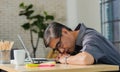 Businessman tired overworked he sleeping over a laptop computer Royalty Free Stock Photo