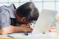 Businessman tired overworked he sleeping over a laptop computer Royalty Free Stock Photo