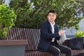 Asian businessman tired after work, sitting on a bench with fatigue and headache, has stress and panic attacks Royalty Free Stock Photo