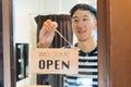 Asian businessman turning round tablet open on door Royalty Free Stock Photo