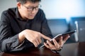 Asian businessman using digital tablet in office Royalty Free Stock Photo