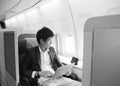 Asian businessman using laptop on first class cabin