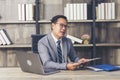 Asian Businessman using laptop at office desk. Man hands typing computer keyboard reading financial graph chart Planning analyzing Royalty Free Stock Photo