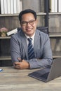 Asian Businessman using laptop at office desk. Man hands typing computer keyboard reading financial graph chart Planning analyzing Royalty Free Stock Photo