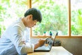 Asian businessman using the smartphone in a coffee shop Royalty Free Stock Photo