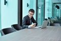 Asian Businessman using smartphone in a conference room Royalty Free Stock Photo