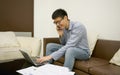 Asian businessman using a smartphone in living room at night Royalty Free Stock Photo