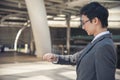 Asian businessman wear suit, eye glasses standing street in modern city. Portrait Young handsome asian man look at bright future Royalty Free Stock Photo