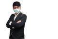 Asian businessman wearing surgical face mask in formal black suit jacket, crossing the arms, studio lighting Royalty Free Stock Photo