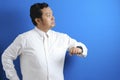 Asian businessman wearing white shirt check time on his wrist watch