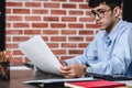 Asian businessman woking with laptop and paper work on desk at office.digital workflow online business lifestyle concept