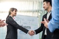 Asian businessman and woman handshake after negotiations for Business deal, merger and acquisition in meeting room. Employee Royalty Free Stock Photo