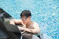 Asian businessman working with laptop in swimming pool. work new normal. lifestyle travel in holiday vacation. Royalty Free Stock Photo