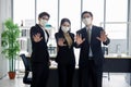 Asian businessmen and businesswoman are wearing mask at workplace to prevent the corona virus outbreak