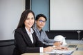 Asian businessmen and group using notebook for business partners discussing documents and ideas at meeting and business women Royalty Free Stock Photo