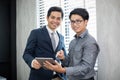 Asian businessmen and group using notebook for business partners discussing documents and ideas at meeting and business women Royalty Free Stock Photo