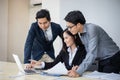 Asian businessmen and group using notebook for business partners discussing documents and ideas at meeting and business women Royalty Free Stock Photo