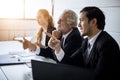 Asian businessmen and group using notebook for business partners discussing documents and ideas at meeting and business women Royalty Free Stock Photo