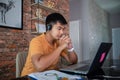 Asian businessmen is using notebook computers and wear headphones for online meetings and working from home