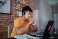 Asian businessmen is using notebook computers and wear headphones for online meetings and working from home Royalty Free Stock Photo