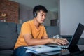 Asian businessmen is using notebook computers and wear headphones for online meetings and working from home Royalty Free Stock Photo