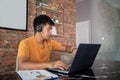 Asian businessmen is using notebook computers and wear headphones for online meetings and working from home Royalty Free Stock Photo