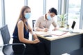 Asian businesspeople teamwork wearing mask for preventing covid19 virus and brainstorming in workplace at office. Healthcare and
