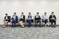 Asian businesspeople waiting in line for job interview Royalty Free Stock Photo