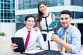 Asian businesspeople working outside with coffee