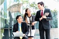 Asian businesspeople working outside on laptop