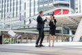 Asian businesswoman and Caucasian businessman throwing paper in the air and raising up hands to celebrated for mission complete Royalty Free Stock Photo