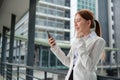 Asian businesswoman celebrating victory success Excited Success. Woman using smartphone at work outside the office Royalty Free Stock Photo